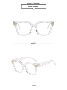 Detail of transparent square frame glasses with elegant gold metal accents on temples