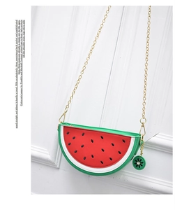 Detail of watermelon crossbody bag with green rind design and gold chain strap