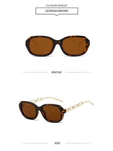 Detail view of leopard print oval sunglasses with elegant golden metal chain temples