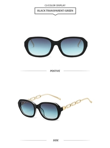 Detail of black sunglasses with bold gold metal chain temples and gradient blue lenses