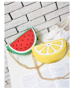 Detail view of watermelon and lemon fruit bags with gold chain straps and zipper