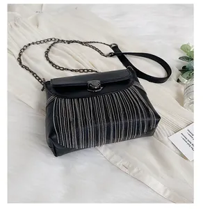 Detailed close-up of a black PU leather tassel bag with silver beaded chain fringe