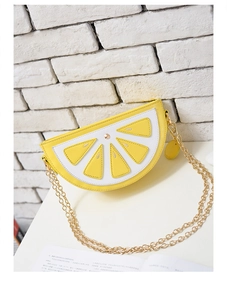 Detailed close-up of a creative lemon-shaped crossbody bag with vibrant yellow PU leather