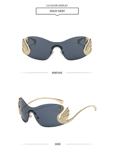 Detail view of gold swan-shaped crystal accents on rimless grey tinted sunglasses