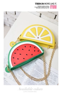 Detail of lemon and watermelon shaped crossbody bags with gold chain straps on a magazine