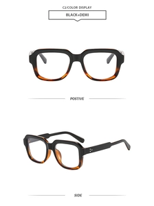 Detail view of square black and demi glasses frame with metallic rivet accents