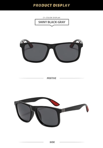 Detail of shiny black square sunglasses with grey lenses and red temple padding