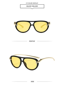 Detail view of double-bridge aviator sunglasses with yellow lenses and gold hinges