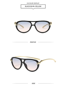 Detail view of aviator sunglasses with dual-bridge frame and twisted gold metal temple design