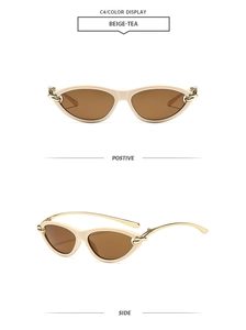 Détail de lunettes de soleil œil de chat beige avec accents métalliques dorés sur les branches
