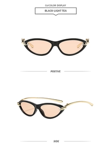 Détail de lunettes œil de chat avec texture dorée et verres thé clair sur monture noire