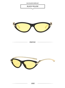 Vue détaillée de lunettes œil-de-chat noires avec verres jaunes et branches chaîne dorée