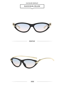 Détail de lunettes œil-de-chat avec verres dégradés et branche en chaîne dorée
