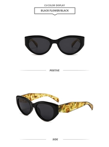 Detail view of cat eye sunglasses showing black frames and yellow tortoise shell temples