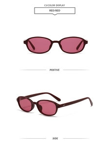 Detail view of oval retro sunglasses with dark red frames and pink tinted lenses