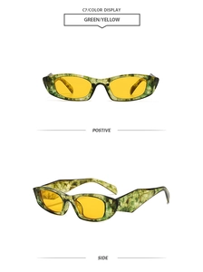 Detail of retro cat-eye sunglasses with green marble frame and yellow lenses
