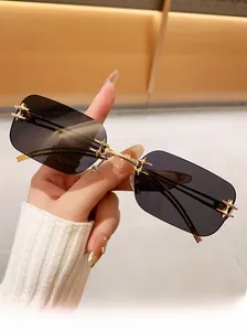Close-up of rimless square sunglasses featuring gold star accents and slim metal temples