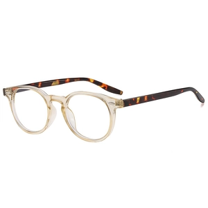 Classic round champagne transparent frame glasses with tortoise shell temples on white base
