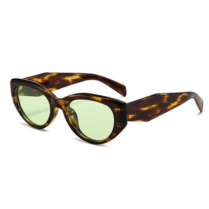 Retro cat-eye sunglasses with tortoiseshell frames and light green tinted lenses