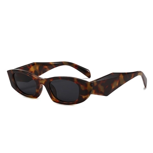Retro cat-eye tortoise shell sunglasses with wide geometric temples and dark lenses