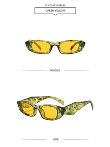 Detail view of vintage narrow sunglasses with green marble frame and yellow lenses