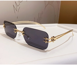 Detail of rimless rectangle sunglasses with gold metal temples and star hinges