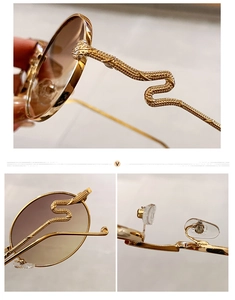Détail de lunettes de soleil en métal doré avec branches serpent et verres dégradés bruns