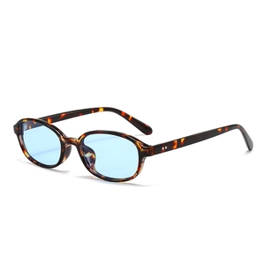 Retro oval tortoise shell sunglasses with light blue lenses and metal rivet details