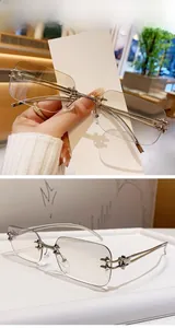 Detail of bright nickel rimless sunglasses with gradient white lenses and metal temples