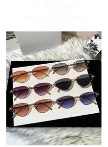 Detail of metal cat-eye sunglasses with gradient lenses and embossed temple hinge designs