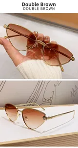 Detail of metal cat-eye sunglasses with gold panther head ornament and brown gradient lens