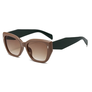 Fashionable oversized cat-eye sunglasses with light brown frames and dark green temples