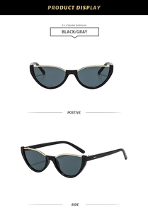 Vue détaillée des lunettes de soleil œil-de-chat noires avec accents en métal doré