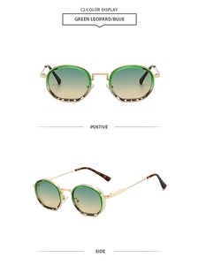 Detail view of round vintage sunglasses with gold frames and green leopard accents