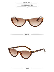 Détail de lunettes de soleil œil-de-chat écaille avec barre dorée et verres dégradés thé