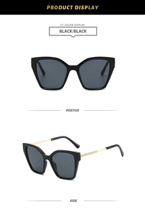 Detail view of cat-eye sunglasses with gold textured temples and black frames