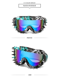 Detail view of camouflage frame ski goggles with rivet studs and blue mirror lens