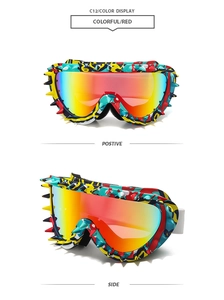 Detail view of colorful graffiti frame sunglasses with red lenses and metallic spikes