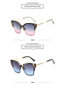 Detail of square cat-eye sunglasses with tortoiseshell frames and gold metal temples
