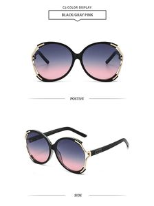 Detail view showing black and gray-pink oversized sunglasses with gold hollow metal trim