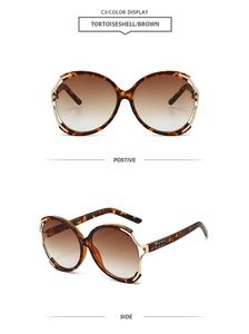 Detail view of tortoiseshell round sunglasses with brown gradient lenses and gold accents