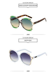 Detail view of round oversized sunglasses with metal cutout edges and patterned temples