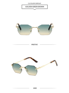 Close-up of rimless octagonal sunglasses with golden metal frame and green brown gradient lens