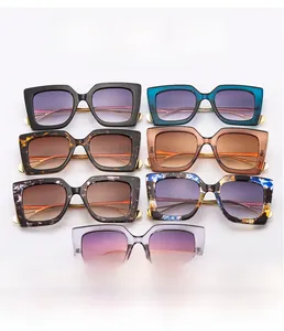 Flat lay of square chunky sunglasses in seven stylish gradient colors and patterns