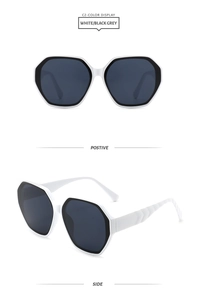 Macro detail of white hexagonal sunglasses with V-textured temples and grey lenses
