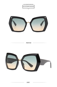 Macro detail of oversized hexagonal sunglasses with black frames and gradient lenses