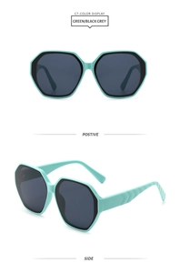 Detail of oversized mint green and black frames with wavy textured temples and grey lenses