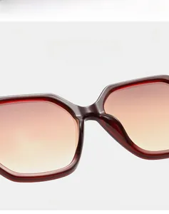 Detail of burgundy oversized square sunglasses frame with gradient lenses and light bridge