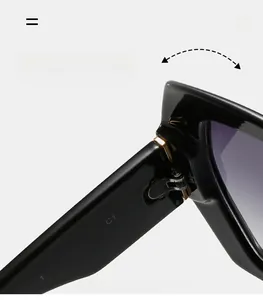Detail of durable gold metal hinge and model specs on large frame black sunglasses
