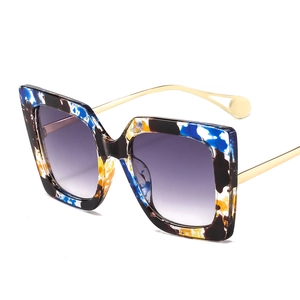 Fashionable oversized square sunglasses with colorful marbled frames and gold metal temples